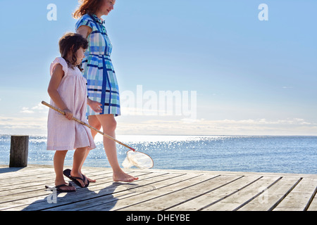 Mutter und Tochter am Pier mit Angeln Net, Utvalnas, Hotels, Schweden Stockfoto