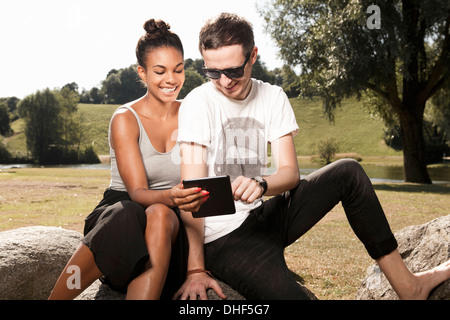 Junges Paar mit digital-Tablette im park Stockfoto