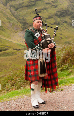 Piper spielt in den Highlands von Schottland, UK Stockfoto