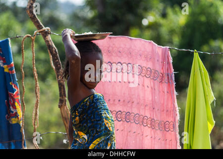 Kajuru, Nigeria. 31. Oktober 2013. Young-Fulani Mädchen Essen auf dem Kopf tragen. Obwohl Fulani meist muslimischen, neigen sie dazu, Krieg bunten Gewand. Fulanis sind traditionell nomadischen Leute, Rinder, Ziegen und Schafe hüten. Sie sind eines der größten nomadischen Volksgruppen in der Welt, über mehrere Gebiete verbreitet. Die Fulani folgen einen Verhaltenskodex bekannt als Pulaaku, bestehend aus den Qualitäten von Geduld, Selbstbeherrschung, Disziplin, Klugheit, Bescheidenheit, Achtung vor anderen Menschen (einschließlich Feinde), Weisheit, Eigenverantwortung, Gastfreundschaft, Mut und harte Arbeit. (Kredit-Bild: © Zsolt R Stockfoto