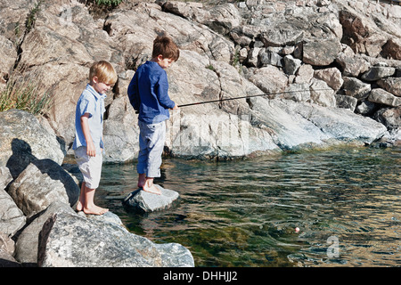 Zwei jungen stehen auf Felsen, Angeln, Utvalnas, Schweden Stockfoto