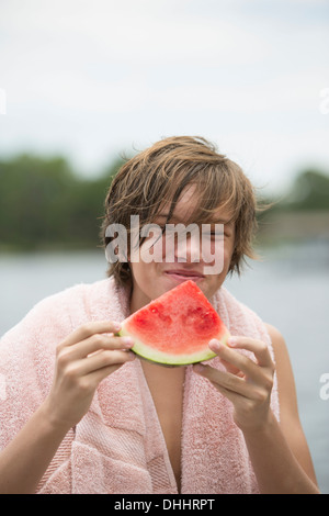 Porträt eines jungen Essen ein Stück Wassermelone Stockfoto