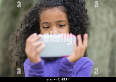 Nahaufnahme von jungen Mädchen im Park Videospiel Hand gehalten Stockfoto