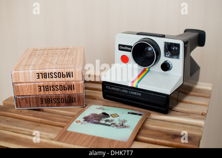 Eine weiße, Regenbogen-Streifen Polaroid Onestep SX - 70 Kamera und unmöglich PX 680 Color Schutz American Woods Edition Film. Stockfoto