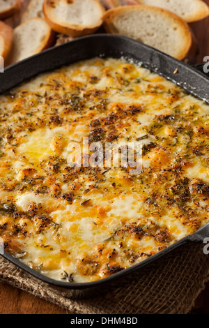 Gebackener Fontina-Käse-Dip mit geröstetem Brot Stockfoto