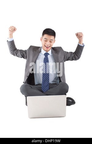 Jungunternehmer am Boden in der Nähe von einem laptop Stockfoto