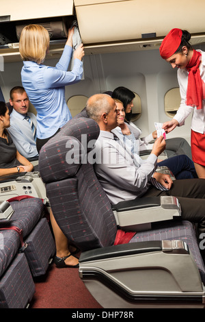 Flight Attendant Passagier Tickets in Flugzeug-Kabine kontrollieren Stockfoto