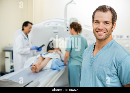 Krankenschwester mit Kollegen und Arzt bereitet Patienten für CT-Scan Stockfoto