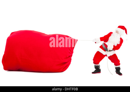 Santa Claus ziehen eine große Geschenktüte Stockfoto