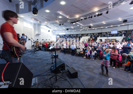 Gemeinde, Teilnahme an zeitgenössischen Anbetungsmusik während Sonntagsgottesdienst in der großen modernen Könige Community Church. Stockfoto