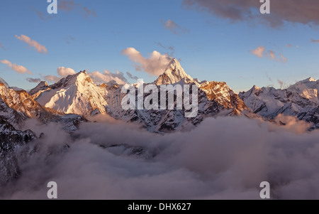 Ama Dablam Gipfel (6856 m) über den Wolken im weichen Abendlicht. Stockfoto