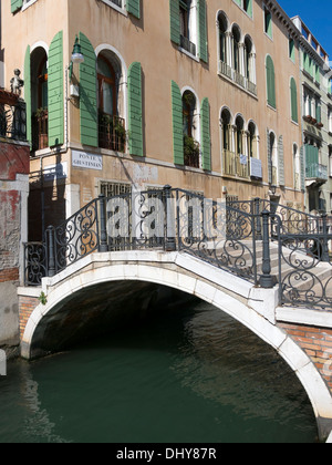 Weiße Stein Bogen Brücke Pont Giustinian mit schmiedeeisernen Geländern über venezianischen Kanal, Venedig, Italien. Stockfoto