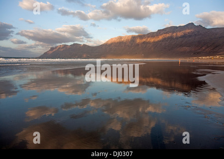 schöne Reflexion der Wolken und Klippe Küste in die flache Weite des Wassers am Famara Strand Stockfoto