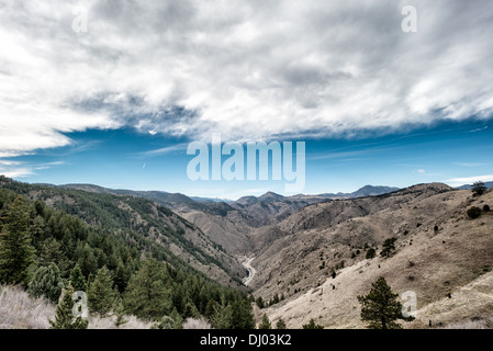 Clear Creek Canyon vom Lookout Mountain Golden Colorado Herbst / GOLDEN, Colorado, Vereinigte Staaten – Clear Creek Canyon vom Lookout Mountain aus gesehen, mit der Straße entlang des Baches weit unten und schneebedeckten Front Range Gipfeln am Horizont. Die Wände des Canyons legen präkambrisches kristallines Gestein frei – eines der ältesten Materialien an der Oberfläche entlang der Front Range von Colorado – das von Clear Creek geschnitten wird, während es etwa 66 Meilen (106 km) von der Nähe des Loveland Pass zum South Platte River abfällt. Stockfoto