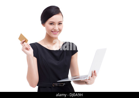 Fröhliche Geschäftsfrau Online-Einkäufen mit Laptop und Bank-Karte Stockfoto