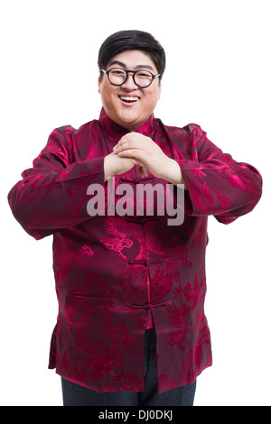 Junger Mann in Tang Anzug Gruß für Chinese New Year Stockfoto