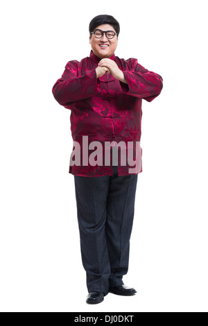 Junger Mann in Tang Anzug Gruß für Chinese New Year Stockfoto