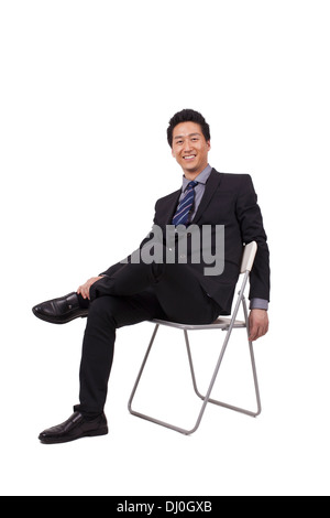 Fröhliche Geschäftsmann Sitzhaltung Stockfoto