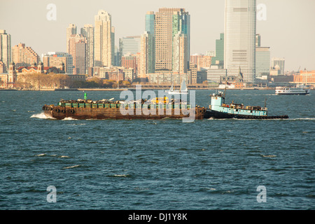 Schlepper bewegt ein Schiff voller Müll, Hudson River, New York City, Vereinigte Staaten von Amerika. Stockfoto