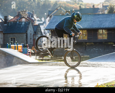 Ein Teenage Boy sein BMX Fahrrad tun Fuß Marmelade Endo Stunts auf einem Skateboard/BMX Park UK Stockfoto