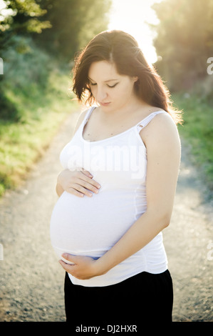 Schöne schwangere Frau draußen in der Natur Stockfoto