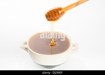 saftige Honig in einer Tasse und Löffel Stockfoto