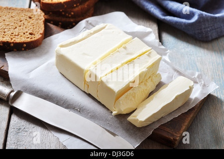 In Scheiben geschnittene Butter auf hölzernen Cutting Board closeup Stockfoto