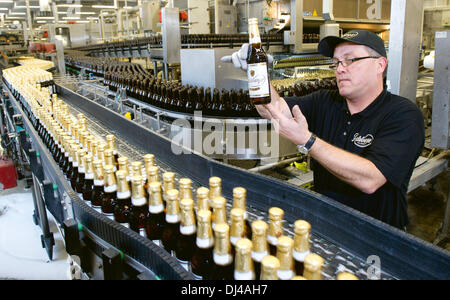 Radeberg, Deutschland. 19. November 2013. Joerg Hormes, Direktor für Qualität und Füllung, prüft die Flaschen in die Abfüllung in der Radeberger Export Bierbrauerei in Radeberg, Deutschland, 19. November 2013. Foto: SEBASTIAN KAHNERT/Dpa/Alamy Live News Stockfoto