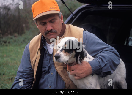 Hochland Vogel Jäger sitzen mit englischer Setzer an der Heckklappe eines SUV in Indiana Stockfoto