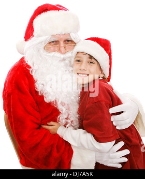 Niedlicher kleine Junge gibt Santa Claus eine große Umarmung. Isoliert auf weiss. Stockfoto