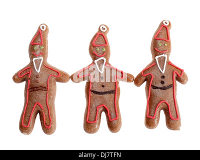 Drei braune Lebkuchen Santa Klausel Figuren mit Farbe Vereisung Schuss auf weißem Hintergrund Stockfoto