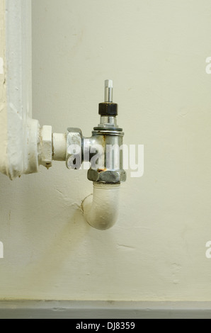 alten Stil altmodischen Konvektion Heizkörper ohne thermostatische Hitze Ventile nicht grün freundlich mit teilweise Leck am Wasserhahn Ventil Stockfoto