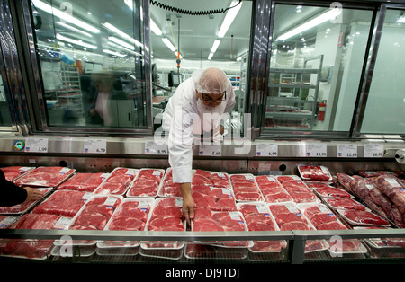 Hispanische Mitarbeiter tragen Lebensmittel Sicherheit Haarnetz Aktien mit Frischfleisch-Abteilung im neu eröffneten COSTCO Lager Einzelhandel Stockfoto