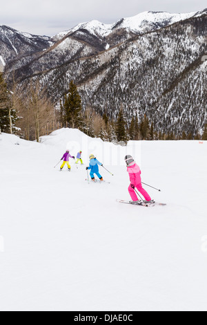 Kinder Skifahren gemeinsam auf verschneiten Hang Stockfoto