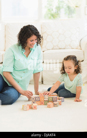 Mischlinge Mutter und Tochter spielen mit Holzklötzen Stockfoto