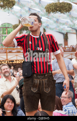 Deutschland, Bayern, München, Oktoberfest, Männer tragen Lederhosen und Bier zu trinken Stockfoto