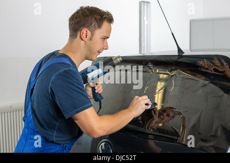 Arbeiter in Garage Tönung Autofenster mit getönte Folie oder film Stockfoto