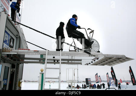 12. Januar 2008 - beobachtete Minneapolis, Minnesota, USA - Lawine Racing Crew Chief JAYME CHENEY, rechts, auf dem Ergometer, die professionellen Motorschlitten-Racer, einschließlich sein Team Mike Schultz, Line-up für das Finale Pro Super Stock. Cheney sagte er war das Motorrad warm zu halten während die Rennen zu beobachten, aber die Teamfahrer verwenden, um in Form zu bleiben. Lawine Racing ist bas Stockfoto