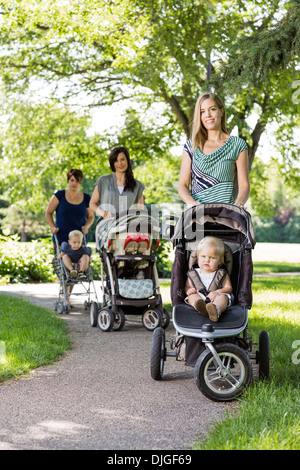 Mütter Baby Kinderwagen im Park Stockfoto