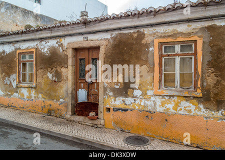 Altbau in einem Zustand des Verfalls mit Farbe und Zement blätterte von den Wänden Stockfoto