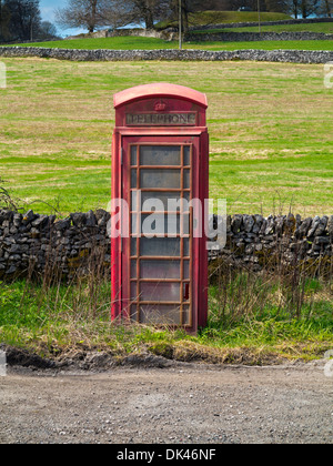 Stillgelegte traditionelle britische rote Telefonzelle auf Straße in der Nähe von Ashbourne im Peak District Nationalpark Derbyshire England UK Stockfoto