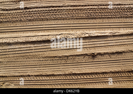 Spuren von Pkw-Reifen auf dem Sandweg Hintergrund. Sonnigen Tag Stockfoto