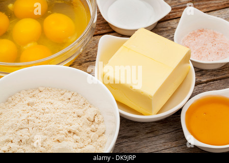 Zutaten für das Backen Gluten frei Kokosbrot: Eiern, Kokosmehl, Butter, Honig, Salz, Backpulver Stockfoto