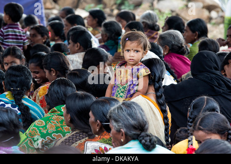 Indische Mädchen mit ihrer Mutter in einer Menschenmenge. Andhra Pradesh, Indien Stockfoto
