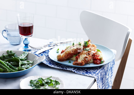 Mahlzeit mit Schale Chicken parmigiana und grüne Bohnen Stockfoto