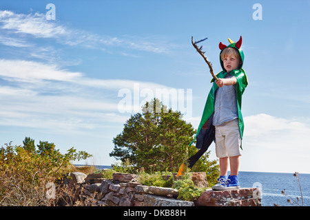 Jungen tragen grüne Kap hält Stock, Eggergrund, Schweden Stockfoto