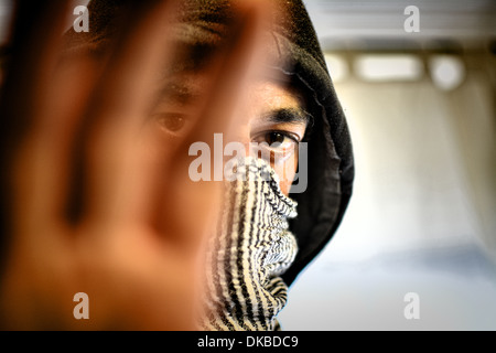 Close-up Hoodie mit Schal um sein Gesicht Stockfoto