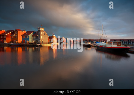 Boote, Schiffe und farbenfrohen Gebäuden Investitur Sonnenaufgang am Reitdiephaven, Groningen, Niederlande Stockfoto