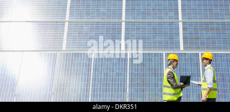 Arbeitnehmer, die Prüfung von Sonnenkollektoren in ländlichen Landschaft Stockfoto