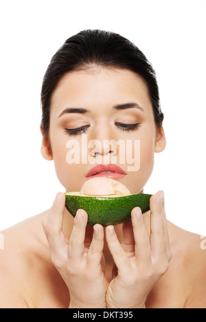 Schöne Frau Gesicht mit Avocado. Isoliert auf weiss. Stockfoto